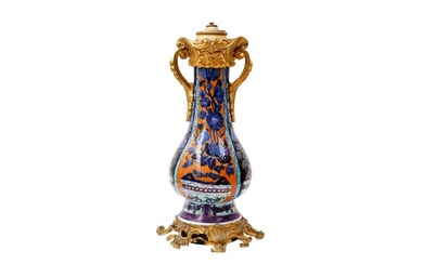 A CHINESE CLOBBERED BLUE AND WHITE ORMOLU-MOUNTED VASE 清康熙 青花加彩花卉紋瓶嵌鎏金銅飾