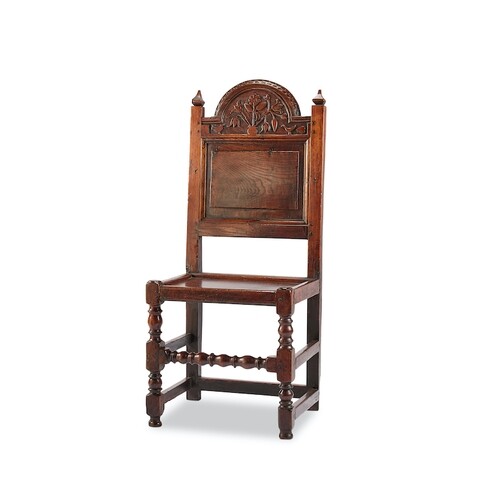 A Charles II oak solid seat chair, Lancashire The arched top...