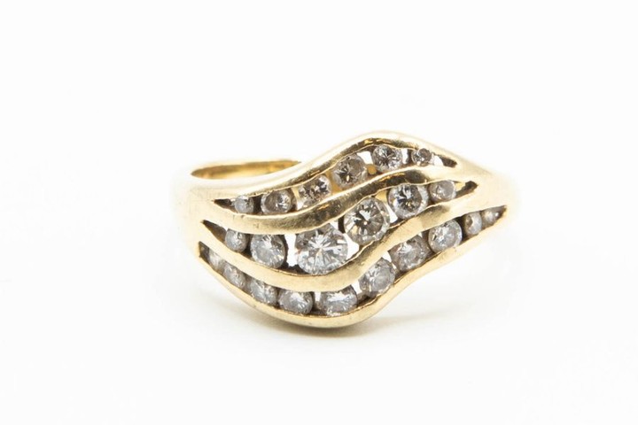 A DIAMOND SET RING, the three curved strand design…