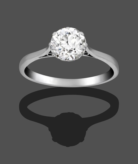 A Diamond Solitaire Ring, the old cut diamond in a white claw setting on a tapered shoulder...
