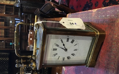 A French brass repeater carriage clock with white enamel dial,...