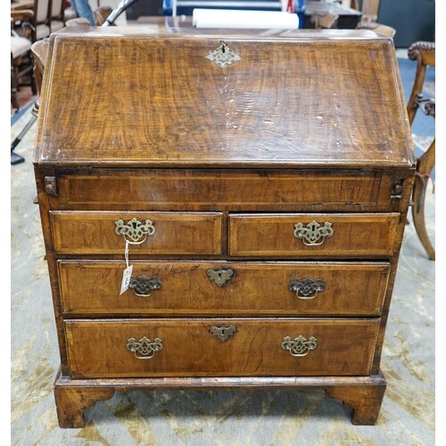A George I feather banded walnut bureau with well interior, ...