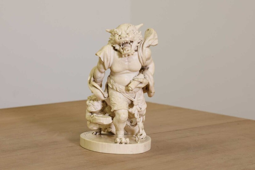 A Japanese solid carved ivory oni okimono