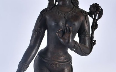 A LARGE 19TH CENTURY INDIAN TIBETAN BRONZE FIGURE OF A STANDING DEITY modelled upon a leaf form base