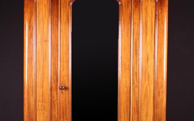 A Victorian Mahogany Wardrobe with moulded cornice above a full length arch-topped mirror panelled d
