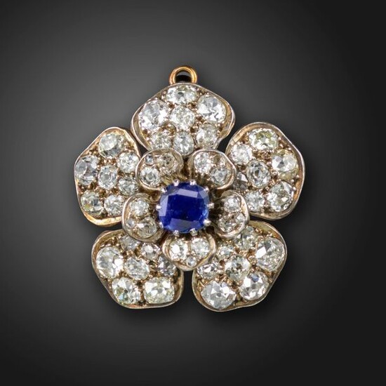 A Victorian sapphire and diamond flowerhead brooch pendant, centred with...