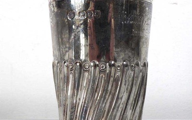 A Victorian silver and parcel gilt beaker with gadrooned decoration,...