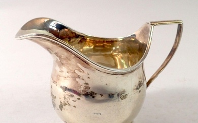 A Victorian silver cream jug, Edward Hutton, London 1881, 10...