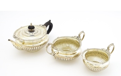 A Victorian silver three piece tea set comprising teapot, su...