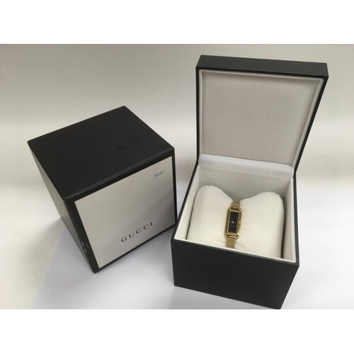 A boxed ladies Gucci dress watch.
