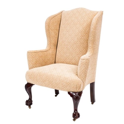 A carved mahogany wing frame armchair in the Georgian taste:...