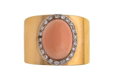 A coral and diamond ring, centring on an oval coral cabochon framed by brilliant-cut diamonds, to a wide band, ring size N