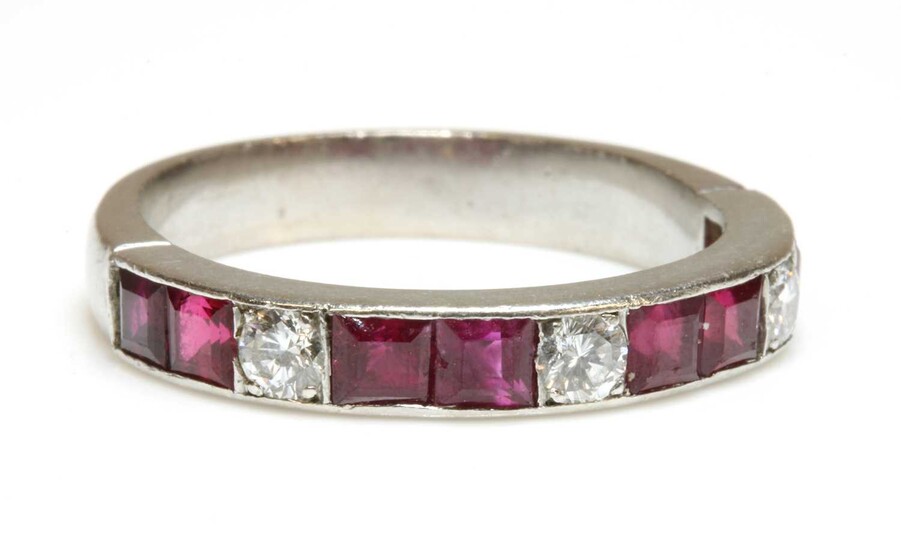A diamond and ruby half eternity ring