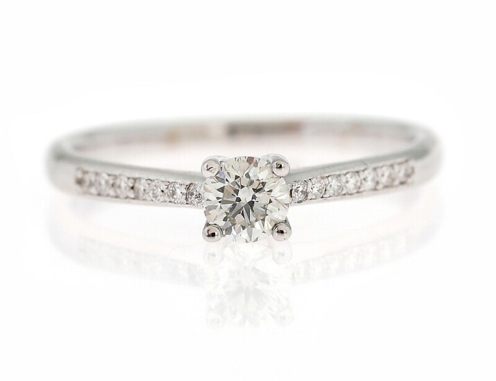 NOT SOLD. A diamond ring set with a brillant-cut diamond weighing app. 0.33 ct. flanked...