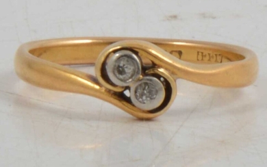 A diamond two stone crossover ring in 22 carat gold.