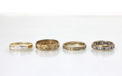 A group of four rings, including a 9ct yellow gold white sto...