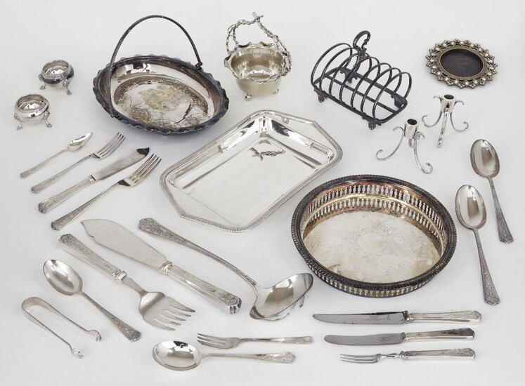A group of silver plate including: a toast rack; a pair of small candlesticks raised on c-scroll legs; a pair of salt cellars; a small gilt metal cruet designed as a bird; a circular basket with fixed handle; a circular dish with pierced edge and a...