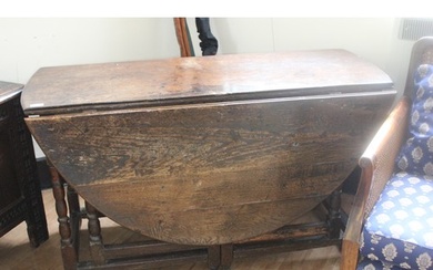 A late 17th/early 18th century oak oval double gateleg table...