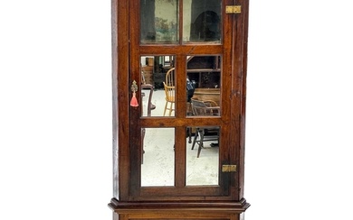 A late George III mahogany standing corner cupboard. The upp...