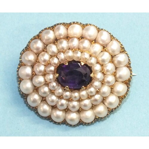 A late-Victorian amethyst and pearl brooch claw-set an oval ...