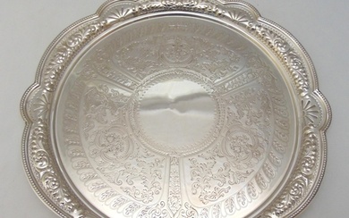 A late Victorian hallmarked silver salver, shaped circular, ...