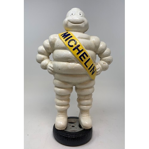 A painted metal Michelin man figure, standing on a wheel, 38...