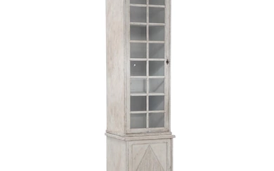 A painted tall narrow display cabinet. Gustavian style, 19th century with later...