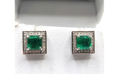 A pair of 18ct white gold, diamond, and emerald earrings, th...