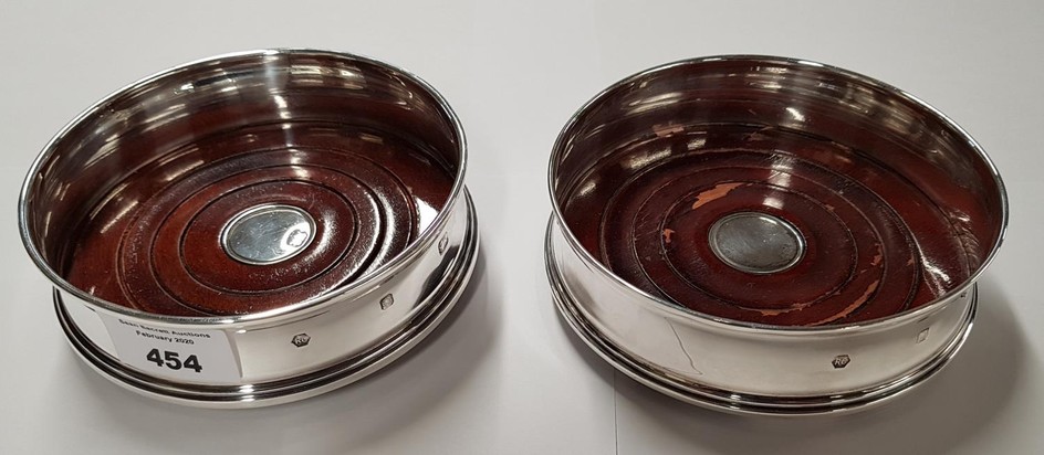 A pair of English silver Coasters.