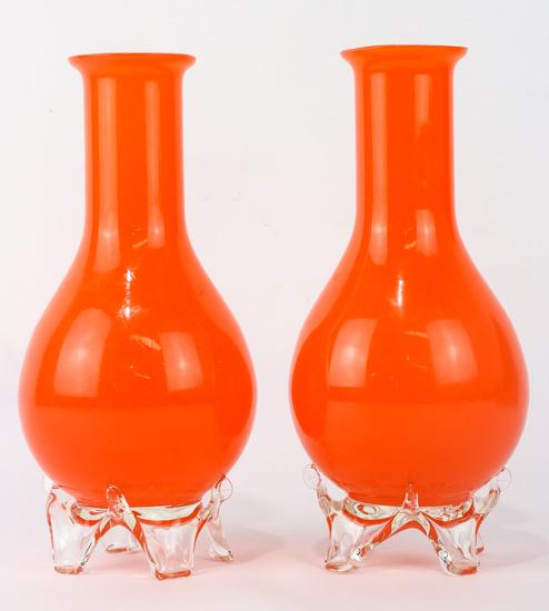 A pair of white cased and orange art glass vases...