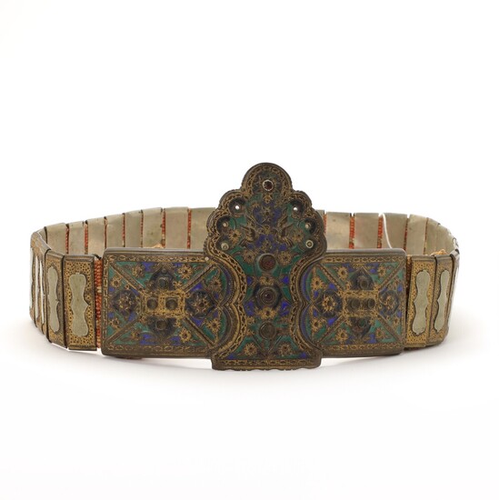 A partial gilt and enamel metal wedding belt decorated with rhinestones. Cast with ornaments and double eagle. Greece. 19th century. L. 95 cm.