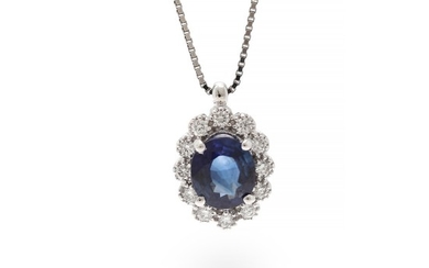 A pendant set with a sapphire weighing app. 0.58 ct. encircled by numerous diamonds, mounted in 18k white gold. Accompanied by chain of 18k white gold.