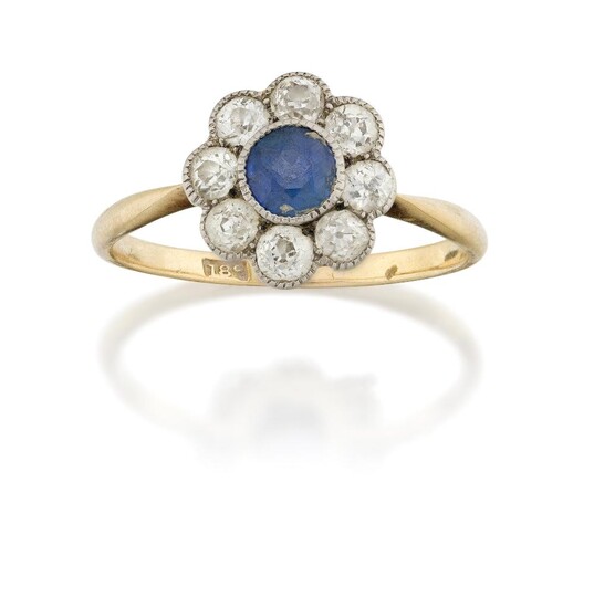 A sapphire and diamond cluster ring, the central circular cut sapphire to an old brilliant-cut diamond surround, hoop stamped 18c, ring size approx. P½