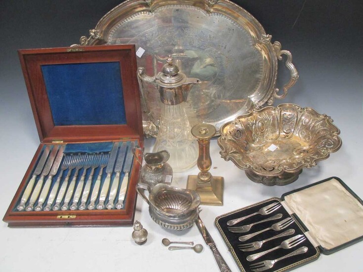 A silver plated two handled tray, a plated fruit bowl, a plate mounted caret jug, a set if plated