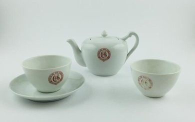 A teapot and two cups in German porcelain