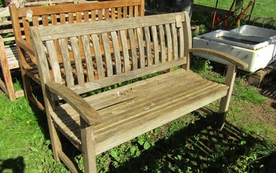 A weathered ‘Canterbury Collection’ teak garden bench with c...