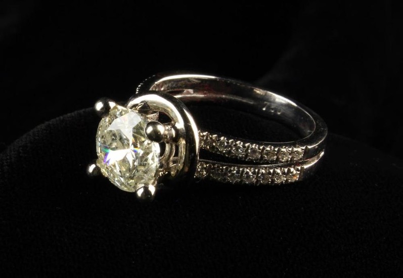 An 18 Carat White Gold and 2.1 Carat Diamond Ring. The round brilliant cut stone raised on a four c