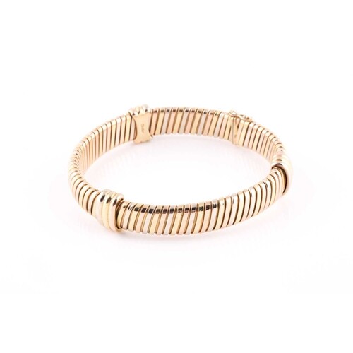 An 18 ct gold Cartier "Colomba" bracelet, of two-colour inte...