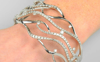 An 18ct gold brilliant-cut diamond openwork, hinged bangle.