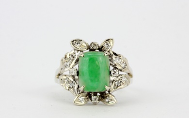 An 18ct white gold (marked 18K) ring set with cabochon jade surrounded by diamonds, (M.5).