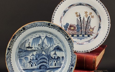 An 18th century English Delft charger, painted in underglaze...