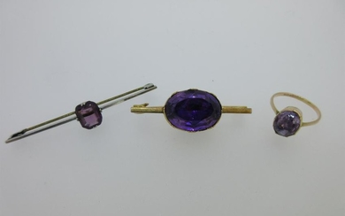 An antique amethyst brooch and two other purple