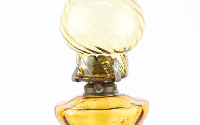 An antique oil lamp with handcrafted caramel / toffee coloured...