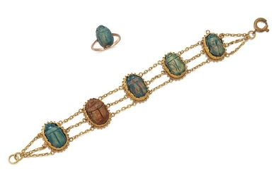 An early 20th century gold mounted scarab bracelet and ring, the bracelet composed of five fancy collet mounted composite Egyptian scarabs, with triple chain-link connections, length 15cm and a ring mounted with a single scarab, ring size K1/2 (2)