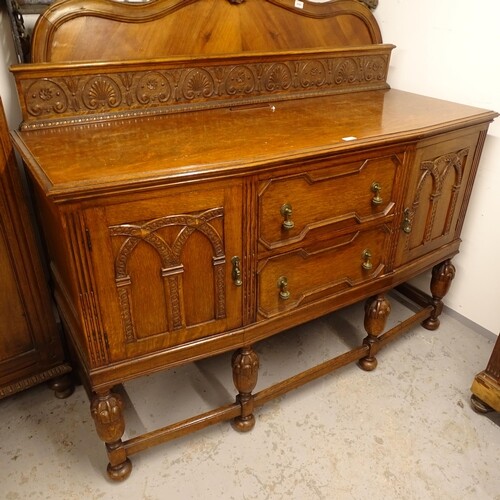 An early 20th century oak sideboard, with 2 carved and panel...