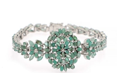 An emerald bracelet set with numerous navette and circular-cut emeralds, mounted in rhodium plated sterling silver. L. app. 18 cm.