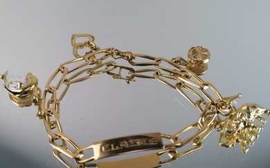 Bracelet gourmette en or jaune "Claire" ornée de breloques. 12,05 grs
