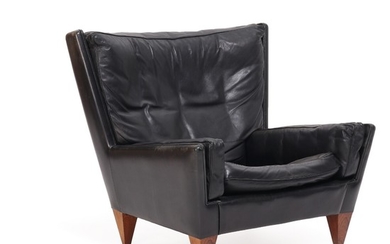 Illum Wikkelsø: Easy chair upholstered with black leather, Brazilian rosewood legs. Manufactured by Holger Christiansen.