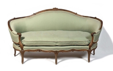 Moulded and carved beechwood sofa with a lively shape, decorated with flowers and foliage, resting on eight arched legs. Louis XV period H: 100 cm, L: 190 cm (accidents and restorations)