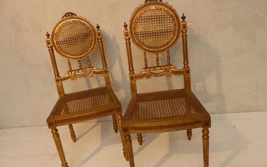 Pair of Louis XVI style chairs in gilded and carved wood.